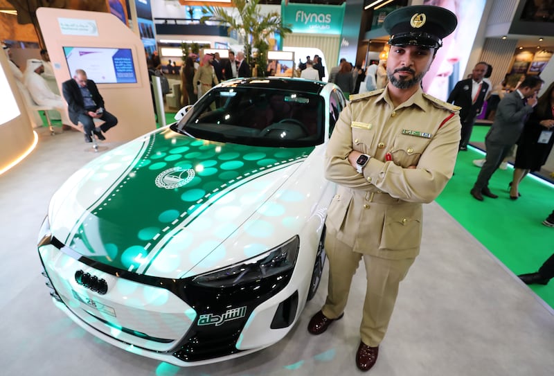 First lieutenant Mohamed Ebrahim Al Suwaidi displays Dubai Police's Audi RS e-tron GT sports car. Chris Whiteoak / The National