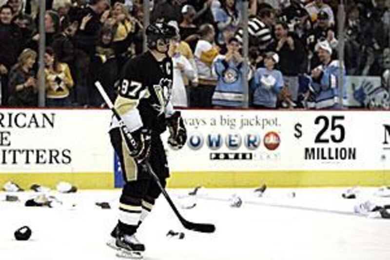 Sidney Crosby skates among spectators' hats after scoring his third goal against New York.