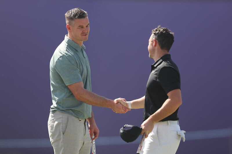 Rory McIlroy shakes hands with teammate Johnny Sexton on the 18th hole following the Pro-Am. Getty Images