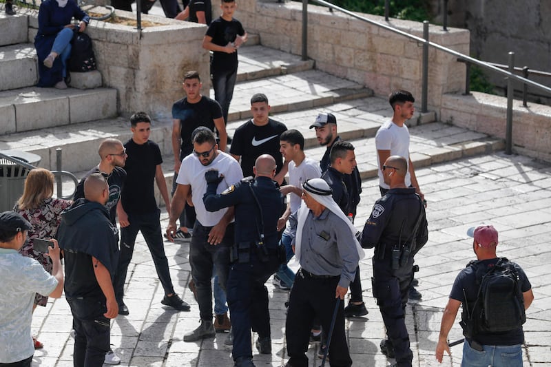 Members of Israeli security forces clear people from Damascus Gate as Israelis mark Jerusalem Day. AFP