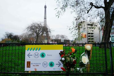 Flowers at the spot where a tourist was stabbed to death near the Eiffel Tower in Paris. AFP