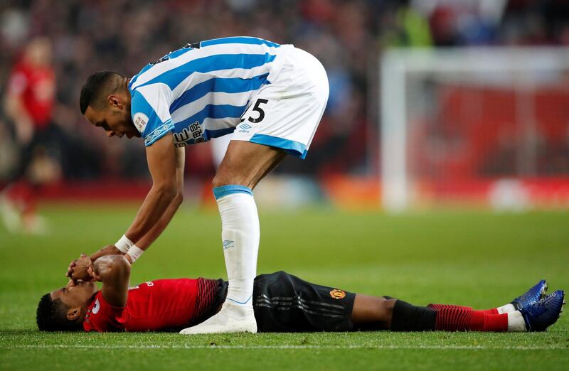 Manchester United's Marcus Rashford and Huddersfield Town's Mathias Jorgensen. Reuters