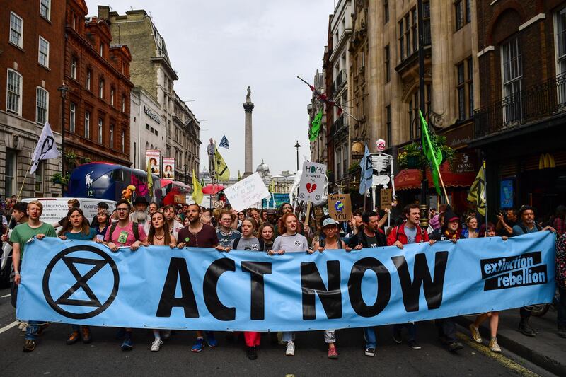 Climate activists from the Extinction Rebellion group march along Whitehall towards the Houses of Parliament in London, U.K., on Tuesday, April 23, 2019. The demonstrators are demanding that the U.K. acknowledge the "crisis" posed by global warming, enact legally binding policies to reduce net carbon emissions to zero by 2025, and form a citizens assembly to oversee changes. Photographer: Chris J. Ratcliffe/Bloomberg