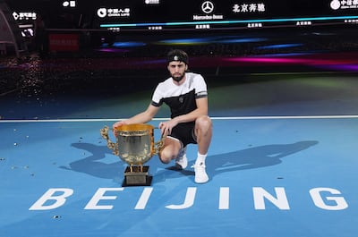 Nikoloz Basilashvili of Georgia poses with the trophy after winning the men's final against Juan Martin del Potro of Argentina at the China Open tennis tournament in Beijing on October 7, 2018.   / AFP / GREG BAKER
