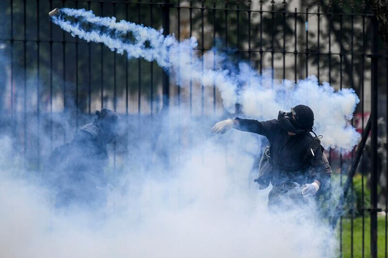 A demonstrator throws a tear gas canister back at riot police outside the Congress while Argentine Deputies began the discussion on the government’s austere 2019 budget, in Buenos Aires. Argentinian Deputies Chamber carries out the first debate of the 2019 budget, with the purpose of achieving the fiscal balance agreed with the International Monetary Fund (IMF), but rejected by unions and social movements that called protest demonstrations.  AFP