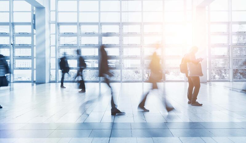 People Walking In Modern Office Building In Germany, Berlin. Getty Images