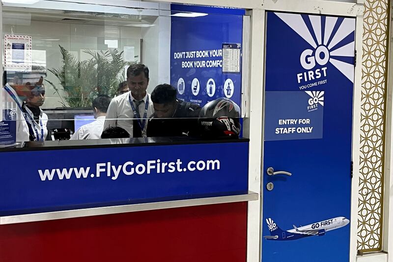 Go First staff work at the airline ticket counter at Indra Gandhi International Airport in New Delhi. AP