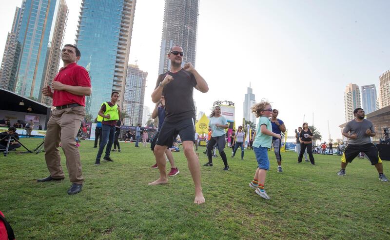 DUBAI, UNITED ARAB EMIRATES - Participants doing workout at the closing weekend carnival of the second year of the Dubai Fitness Challenge at Burj Park, Dubai.  Leslie Pableo for The National