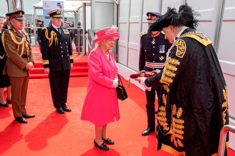 Britain's Queen Elizabeth II on arrival is presented the Keys of Portsmouth by the Mayor (R) as she attends an event to commemorate the 75th anniversary of the D-Day landings, in Portsmouth, southern England.   AFP