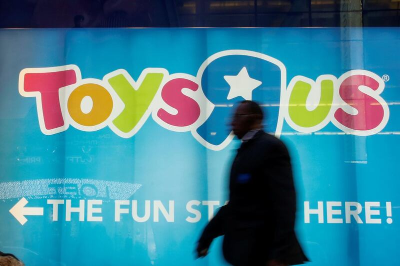 FILE PHOTO - A man passes by Toys R Us store at Times Square in New York, U.S., March 9, 2018. REUTERS/Eduardo Munoz/File Photo