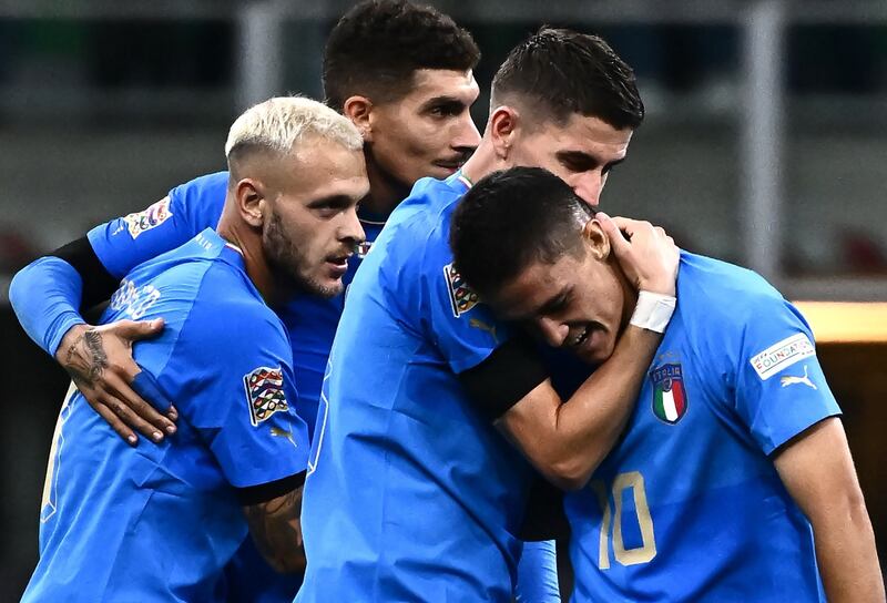 Italy's Giacomo Raspadori (R) celebrates with his teammates after scoring the only goal in the Nations League win against England at the San Siro Stadium in Milan on September 23, 2022. AFP