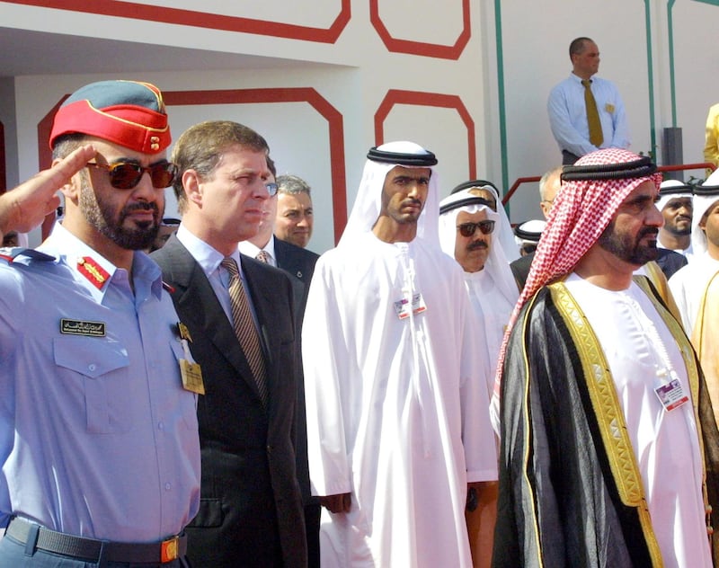 The Crown Prince of Dubai and UAE Minister of Defence sheikh Mohammed Bin Rashid Al-Maktum (R)  stands with Britain's Prince Andrew (2nd, L) and UAE Chief of Staff Sheikh Mohammed bin Zayed (L) saluting, during the opening of the international Dubai 2001 Airshow 04 November 2001. 450 companies from 33 countries including the US, UK, France, Italy, Germany, Czech Republic, South Africa, Canada, The Netherlands and Canada will be represented at Dubai 2001.  AFP PHOTO/Rabih MOGHRABI (Photo by RABIH MOGHRABI / AFP)