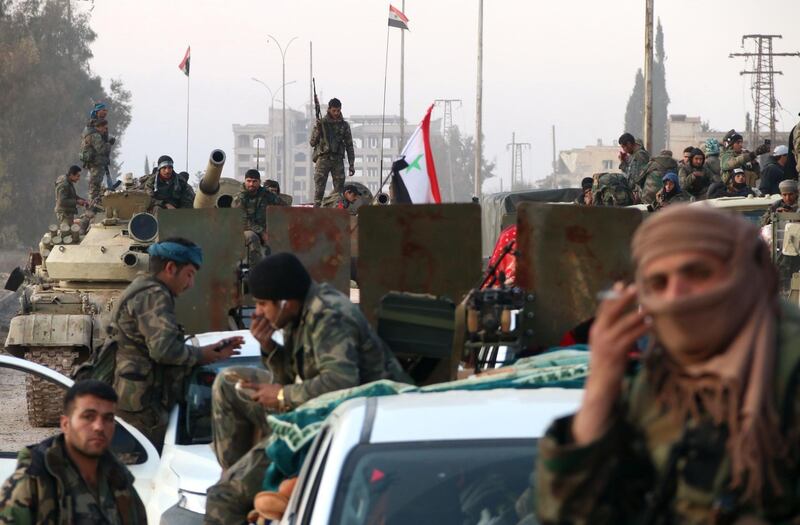 Syrian army soldiers advance on a road in the northern Aleppo countryside.  AFP