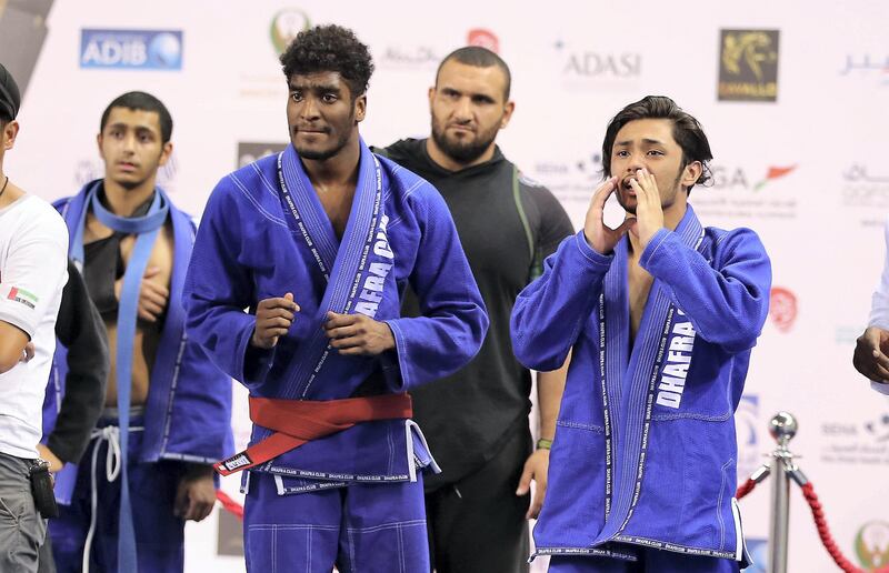 ABU DHABI , UNITED ARAB EMIRATES, September 29 , 2018 :- Team members of Dhafra Club cheering for their team during the Jiu-Jitsu President’s Cup Round -1 held at Al Jazira Club Indoor stadium in Abu Dhabi. ( Pawan Singh / The National )  For Sports. Story by Amith