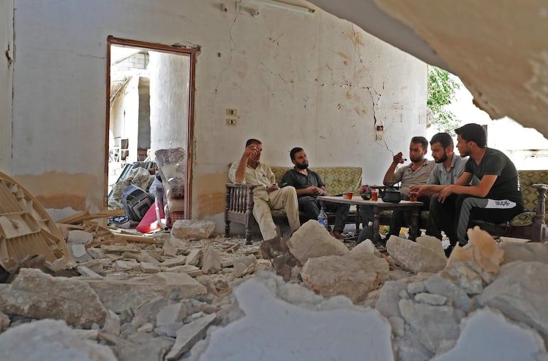 The government offensive displaced residents of Khan Sheikhun, but during a temporary truce Abu Abdullah and his neighbours returned to their destroyed homes where they sat to drink tea on August 3. AFP