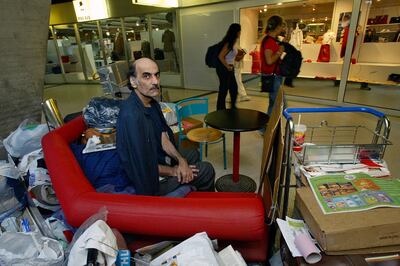 Mehran Karimi Nasseri sits among his belongings at Terminal 1. AP.