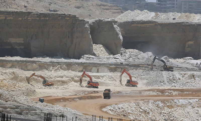 Bulldozers demolish a Mokatam hill to expand the road, as part of a mega project for roads and bridges in the Egyptian capital. EPA