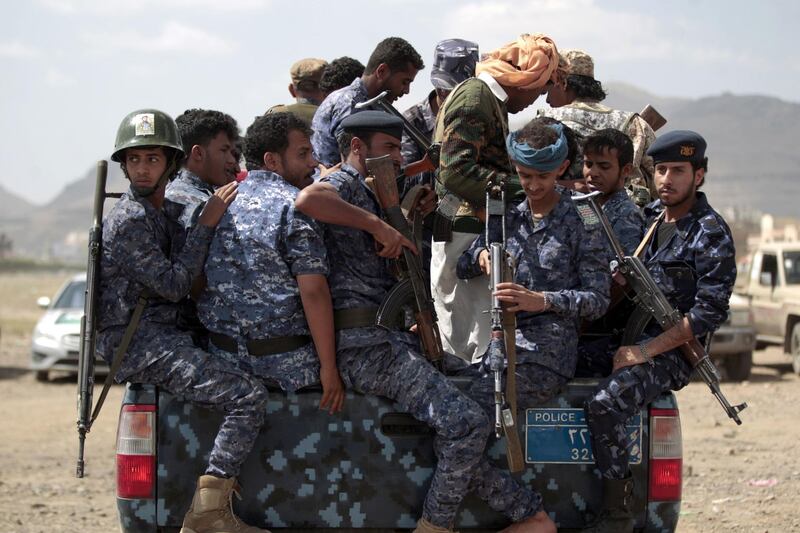 Yemeni Shiite Huthi police forces sit in the back of a military vehicle in the capital Sanaa during a protest against the Saudi intervention in their country on September 17, 2019. The Huthis, who captured the Yemeni capital Sanaa in 2014, have been fighting against a Saudi-led coalition that intervened the following year in support of the internationally recognised government. / AFP / MOHAMMED HUWAIS
