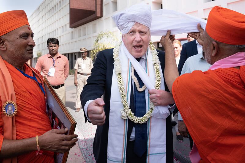 Mr Johnson having a turban placed on his head at Gujarat Bio Technology University, during his two-day trip to India in April. Getty Images