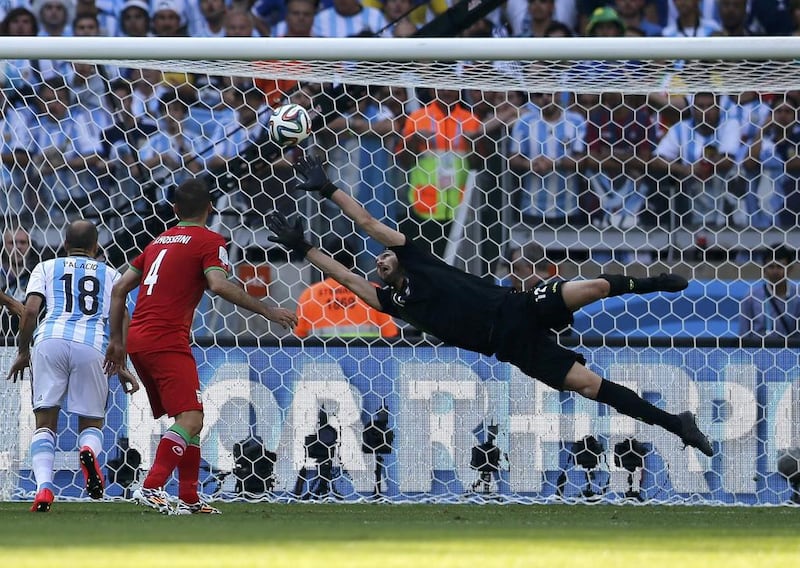 Iran goalkeeper Alireza Haghighi fails to save a goal by Argentina's Lionel Messi, unseen, for the lone goal in a 1-0victory for Argentina on Saturday at the 2014 World Cup. Sergio Moraes / Reuters