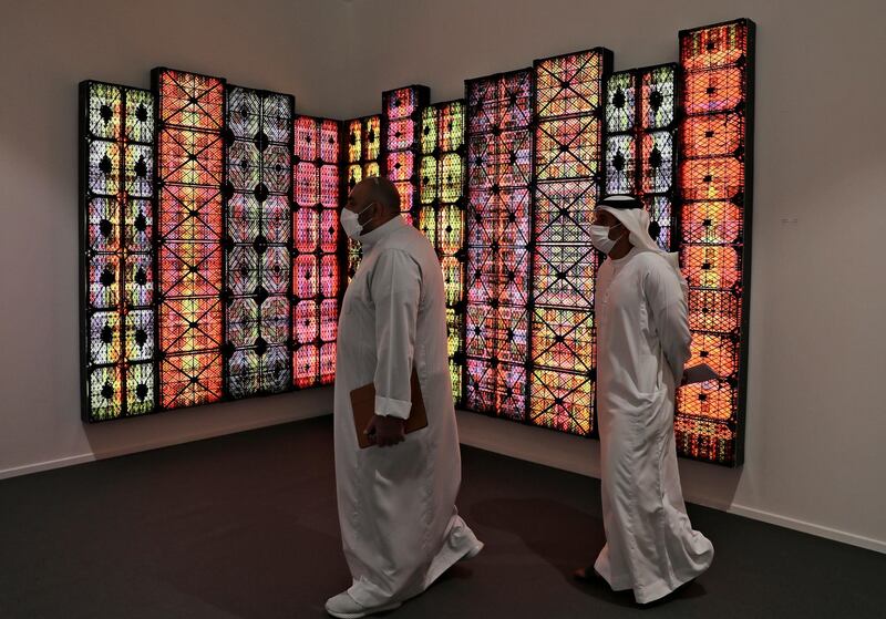 People visit Saudi artist Rashed Al Shashai's work titled Brand 14, Light Boxes, Plastic Cases, at the 14th edition of Art Dubai at Dubai International Financial Centre, DIFC in Dubai. AP Photo