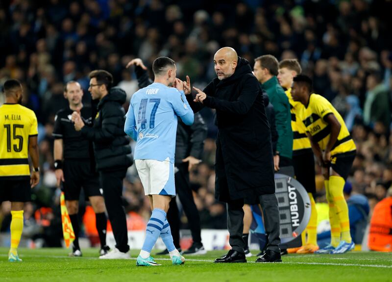 Manchester City manager Pep Guardiola gives instructions to Phil Foden. PA