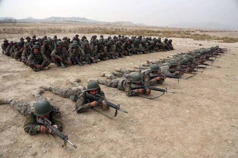 In this Oct. 31, 2018 photo, a group of Afghan National Army soldiers watch others participate in a live fire exercise at the Afghan Military Academy, in Kabul, Afghanistan. When U.S. forces and their Afghan allies rode into Kabul in November 2001 they were greeted as liberators. But after 17 years of war, the Taliban have retaken half the country, security is worse than itâ€™s ever been, and many Afghans place the blame squarely on the Americans. (AP Photo/Rahmat Gul)