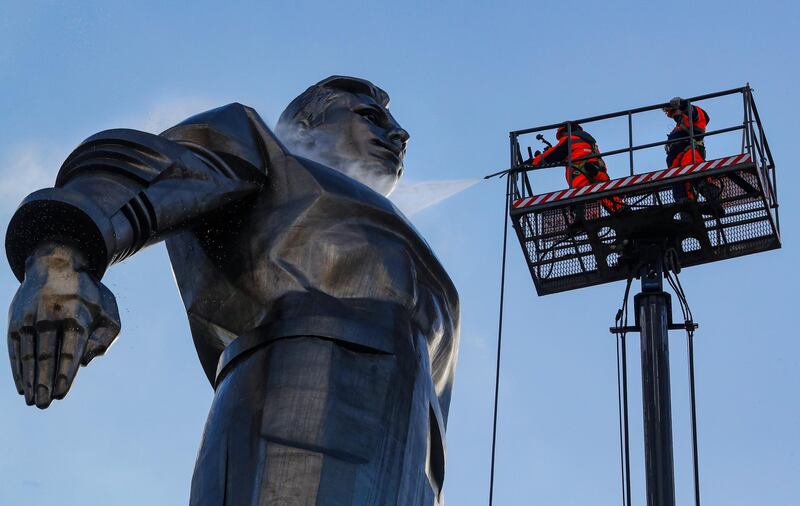 Municipal workers clean the Yuri Gagarin monument in Moscow in preparation for Cosmonaut Day, the 60th anniversary of Yury Gagarin's space flight. EPA