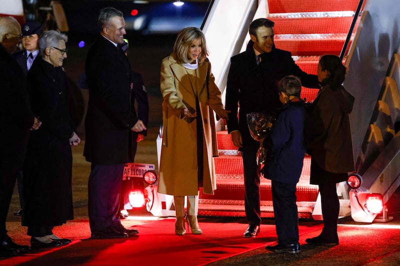 The Macrons are presented with flowers upon their arrival. AFP