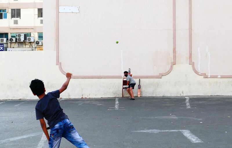 Children playing cricket in a car park in Bur Dubai. Pawan Singh / The National