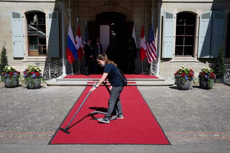 A worker cleans the red carpet at the summit venue. AP
