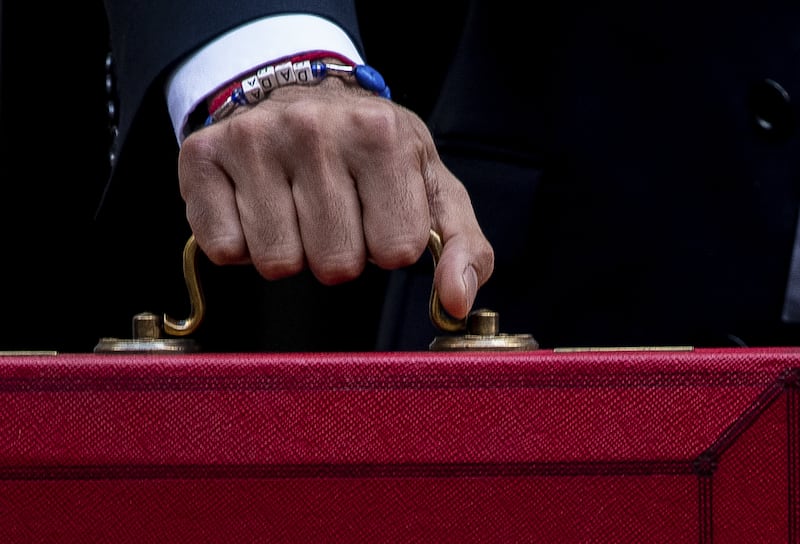 Wrist management: Bar Rolex models, very few people have their wrist snapped as intensively as the UK's chancellor on budget day. With his customary eye for the optics, Mr Sunak has turned this briefcase brandishing occasion into a fashion opportunity and his DADA charm bracelet has garnered the most attention. Getty Images