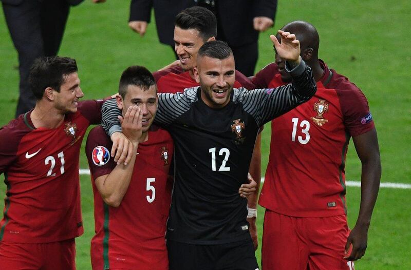 (LtoR) Portugal's Cedric Soares, Raphael Guerreiro, Jose Fonte,  Anthony Lopes and Danilo Pereira celebrate their 1-0 win over France in the Uefa Euro 2016 Final football match between Portugal and France at the Stade de France in Saint-Denis, north of Paris, on July 10, 2016. Miguel Medina / AFP