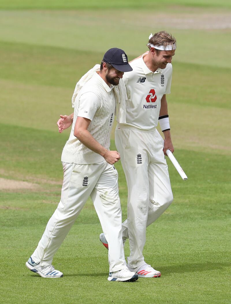 England's Chris Woakes, left, and Stuart Broad walk off the field after their win on the fifth day of the third Test at Old Trafford in Manchester on Tuesday. AP
