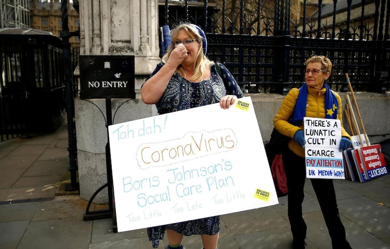 A protester stands outside the UK Houses of Parliament following the outbreak of coronavirus, in London on March 11, 2020. Reuters