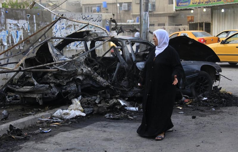 A woman inspects the site of a deadly car bomb attack that killed her sister in Baghdad’s eastern Mashtal neighbourhood. Hadi Mizban / AP





