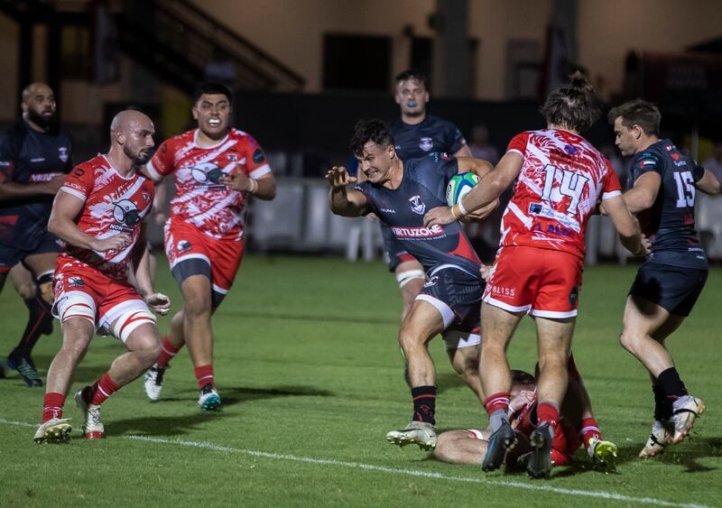 Dubai Exiles' Robbie Deegan runs with the ball.