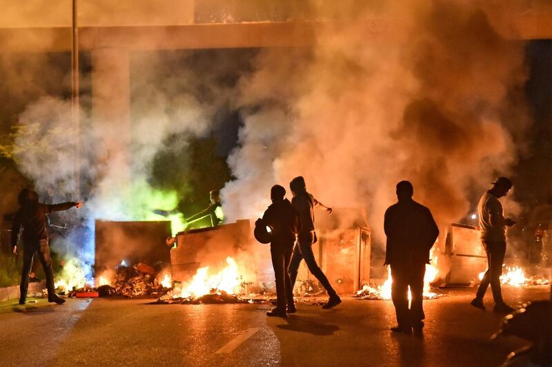Lebanese supporters of outgoing prime minister Saad Hariri block a road with burning dumpsters in the Qasqas neighbourhood of the capital Beirut. AFP