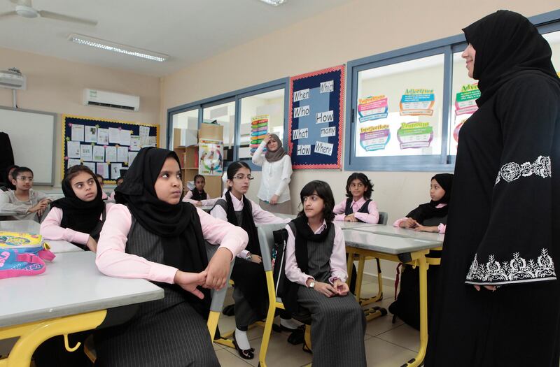 Dubai, United Arab Emirates - September 8, 2013.  Eman Ali ( English teacher )  interacts with grade 6 students during their first day of school in Nadd Al Hamar Primary School for Basic Education Cycle 2.  ( Jeffrey E Biteng / The National )  Editor's Note; Wafa I reports.  *** Local Caption ***  JB080913-Publicschool14.jpg