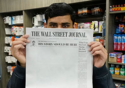 A New York vendor at Grand Central Station holds a copy of the Wall Street Journal with its blank page protest. AFP