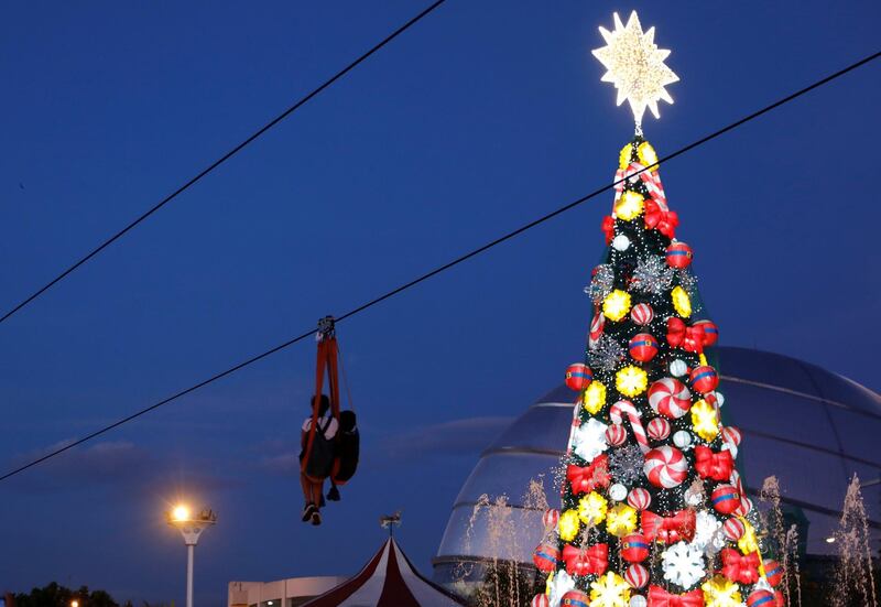 A zipline passes through a lighted Christmas tree installation at a amusement park during holiday season in Pasay, Metro Manila, Philippines. REUTERS/Dondi Tawatao
