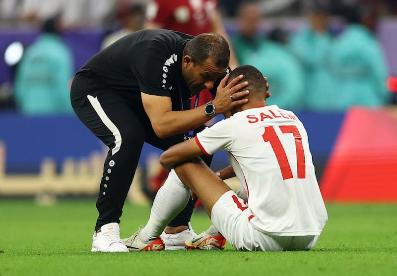 Jordan's Salem Al Ajalin is consoled after the match. Reuters