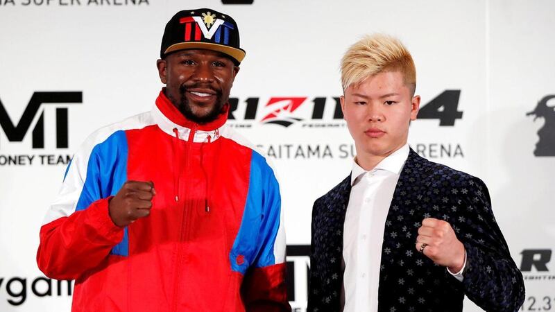 Undefeated boxer Floyd Mayweather Jr poses with his opponent Tenshin Nasukawa during a news conference in Tokyo. Reuters