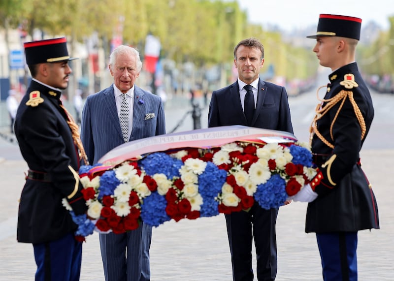 Britain's King Charles III and French President Emmanuel Macron lay a wreath of remembrance at the Tomb of the Unknown Soldier at the Arc de Triomphe in Paris. AFP