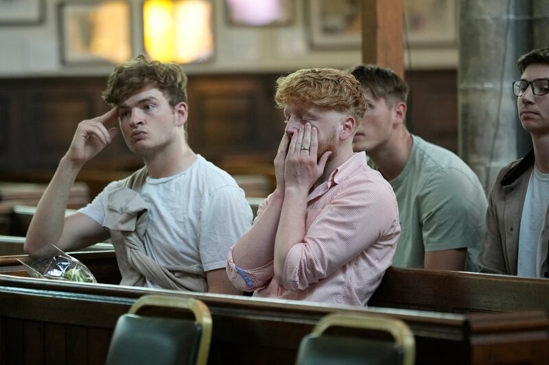 People attend a vigil at St Peter’s Church. Getty