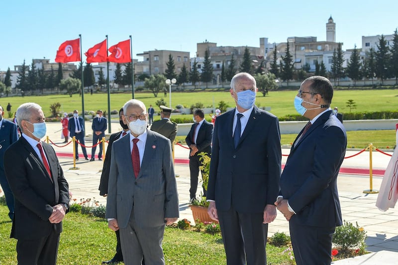 A handout picture provided by the Tunisian Presidency Press Service on April 9, 2021 shows Tunisian President Kais Saied (2-R), Prime Minister Hichem Mechichi (R) and Assembly (parliament) speaker Rached Ghannouchi (2-L) in the capital Tunis, during a ceremony to commemmorate 'Martyrs' Day'.  === RESTRICTED TO EDITORIAL USE - MANDATORY CREDIT "AFP PHOTO / HO / PRESIDENCY FACEBOOK PAGEE " - NO MARKETING NO ADVERTISING CAMPAIGNS - DISTRIBUTED AS A SERVICE TO CLIENTS ===
 / AFP / Tunisian presidency Facebook page / - / === RESTRICTED TO EDITORIAL USE - MANDATORY CREDIT "AFP PHOTO / HO / PRESIDENCY FACEBOOK PAGEE " - NO MARKETING NO ADVERTISING CAMPAIGNS - DISTRIBUTED AS A SERVICE TO CLIENTS ===
