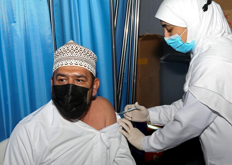 An Omani man receives a dose of the Pfizer/BioNTech Covid-19 vaccine at the Sultan Qaboos Sports Complex in Oman's capital Muscat. AFP