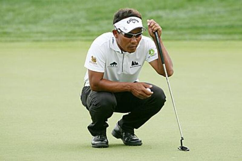Thongchai Jaidee lines up a putt on the fifth hole yesterday. He finished the day three-under par.