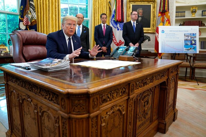 President Donald Trump speaks as he receives a briefing on the 2020 hurricane season in the Oval Office of the White House, Thursday, May 28, 2020, in Washington. Watching are Commerce Secretary Wilbur Ross and Neil Jacobs, assistant Secretary of Commerce for Environmental Observation and Prediction, and Pete Gaynor, administrator of the Federal Emergency Management Agency. (AP Photo/Evan Vucci)