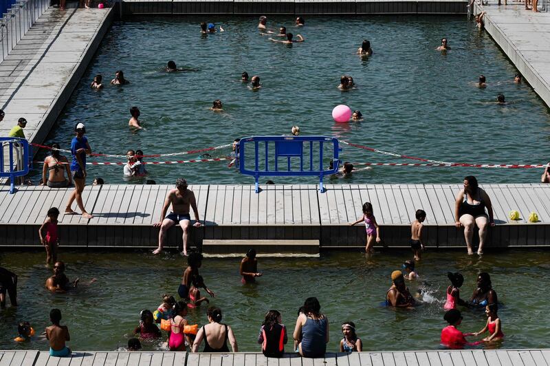 People cool off at floating pools set up on the Ourcq canal in Paris.  AFP